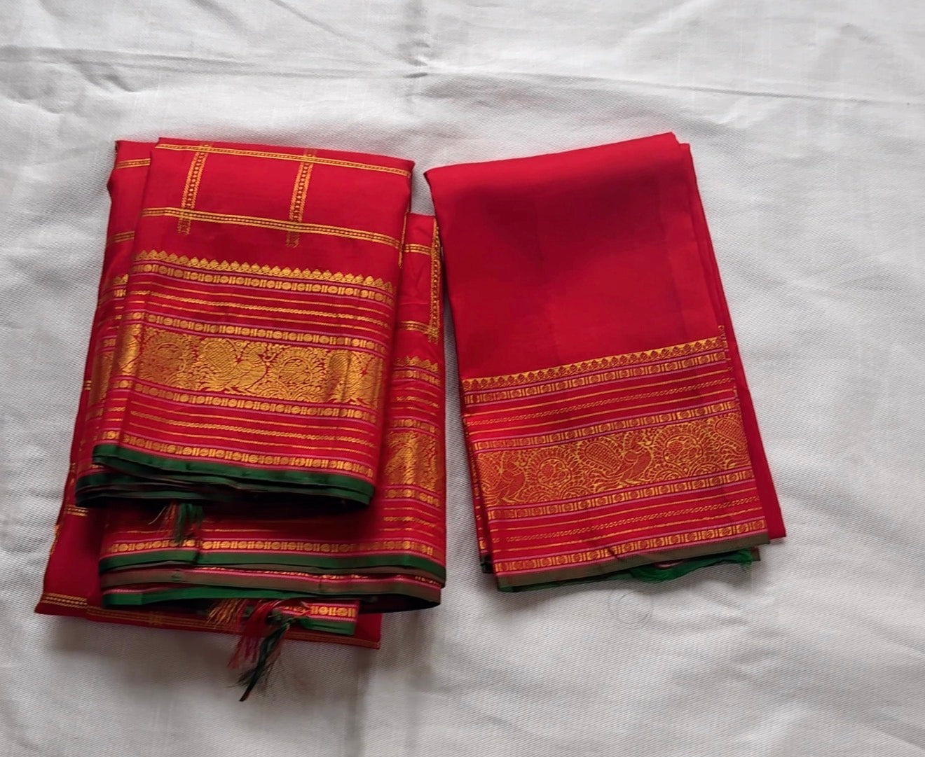 Red Kanjeevaram silk saree with zari kattam and peacock butta pattern close detail view