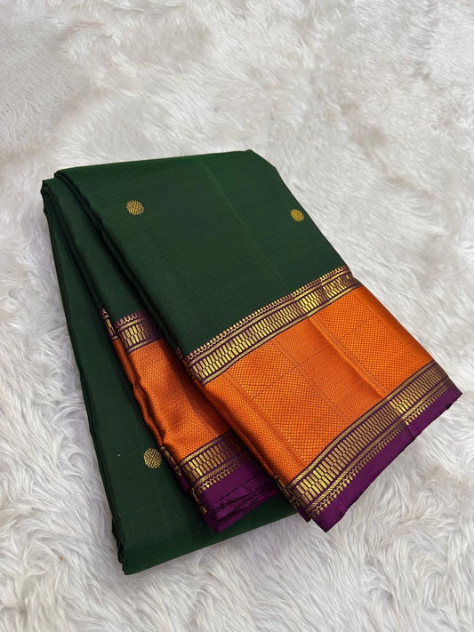 Kanjivaram silk saree deep forest green with burnt orange gold border folded view