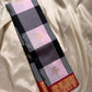 Folded checked Pure Kanchipuram Silk Saree in black, charcoal, and lilac blocks with gold motifs and red zari woven border
