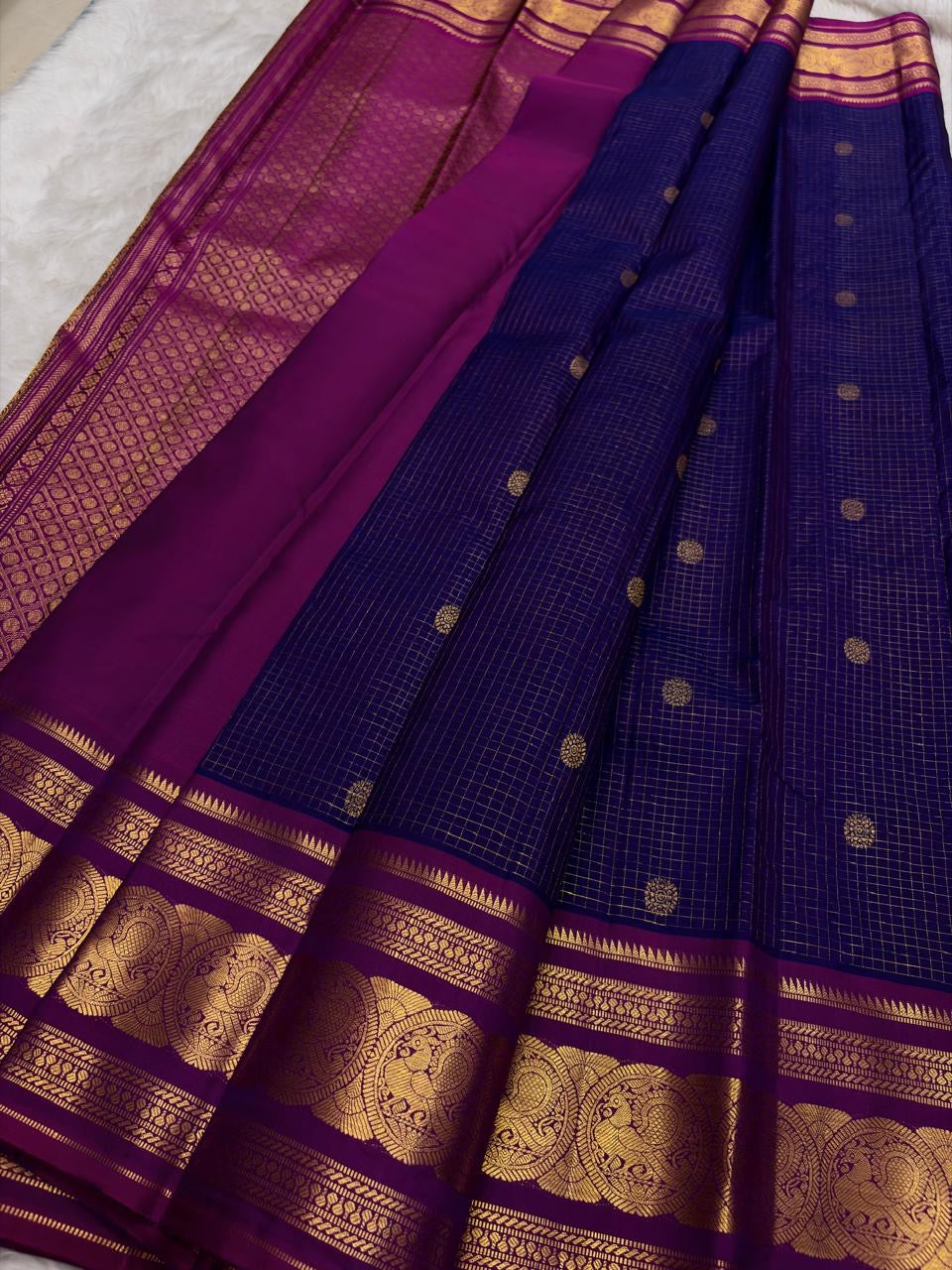Green Kancheepuram silk saree featuring peacock motifs and zari kattam border with gold zari detail