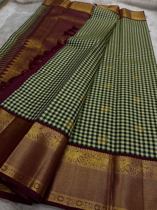 Forest jade Kanchipuram silk saree with ivory grid checks and maroon antique gold zari border folded view