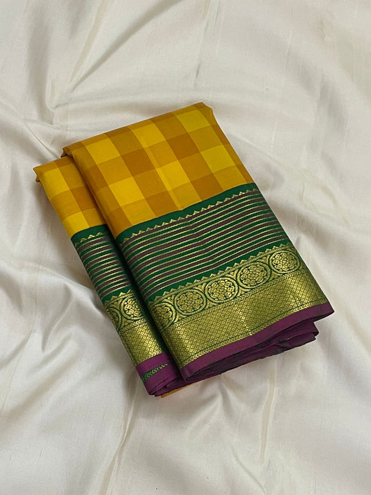 Pure Kanchipuram silk saree turmeric manjal ochre kanchi kattam checks folded view with green traditional gold zari border Idam Living