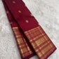 Arakku red pure silk Kanchipuram saree with antique gold mayil chakram buttas and a detailed peacock and arai maadam pallu.