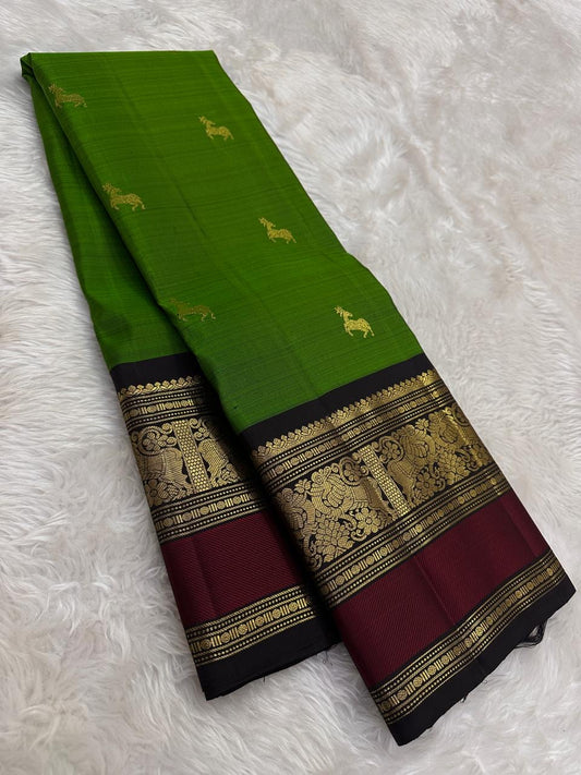 Leafy green silk saree with horse motifs and burgundy border draped view