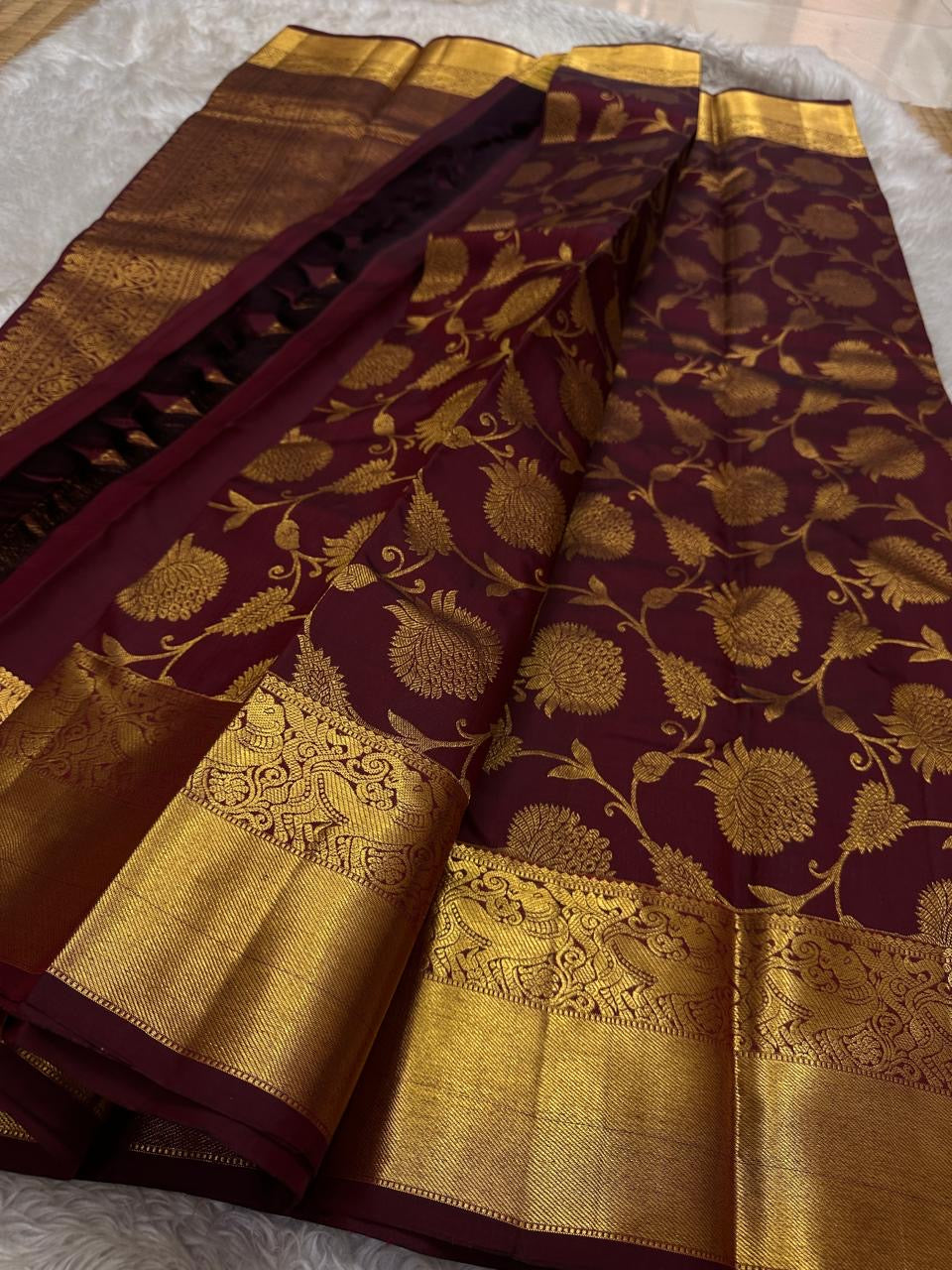 Brown Kanchipattu silk saree with floral butta jaal design folded display view