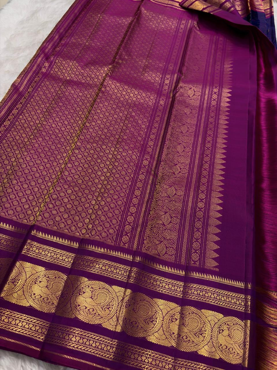 Green silk Kanchipuram saree with sorgavaasal mayil motifs and zari kattam border pallu detail view