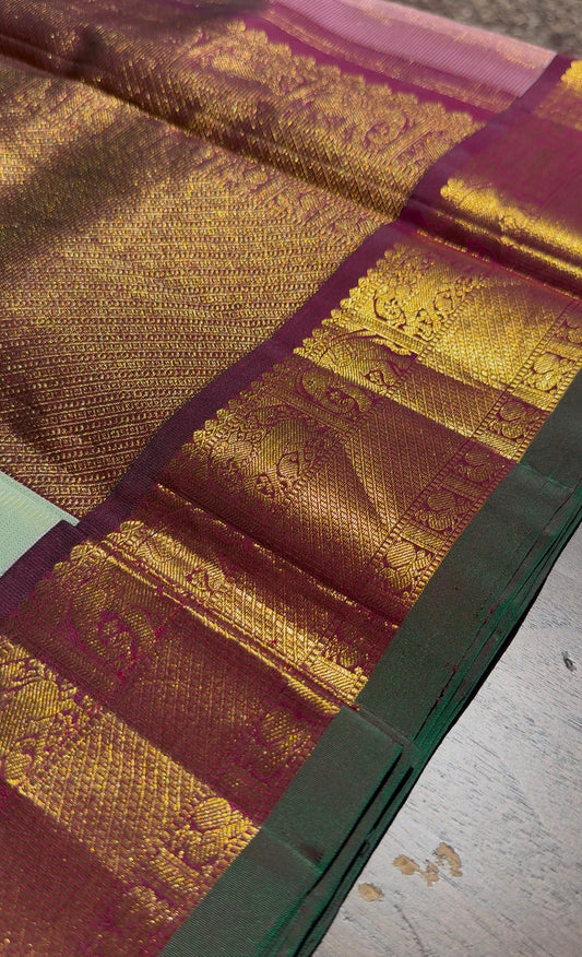 Soft pastel Kanjivaram saree draped view showing delicate vairaoosi zari shimmer across silk