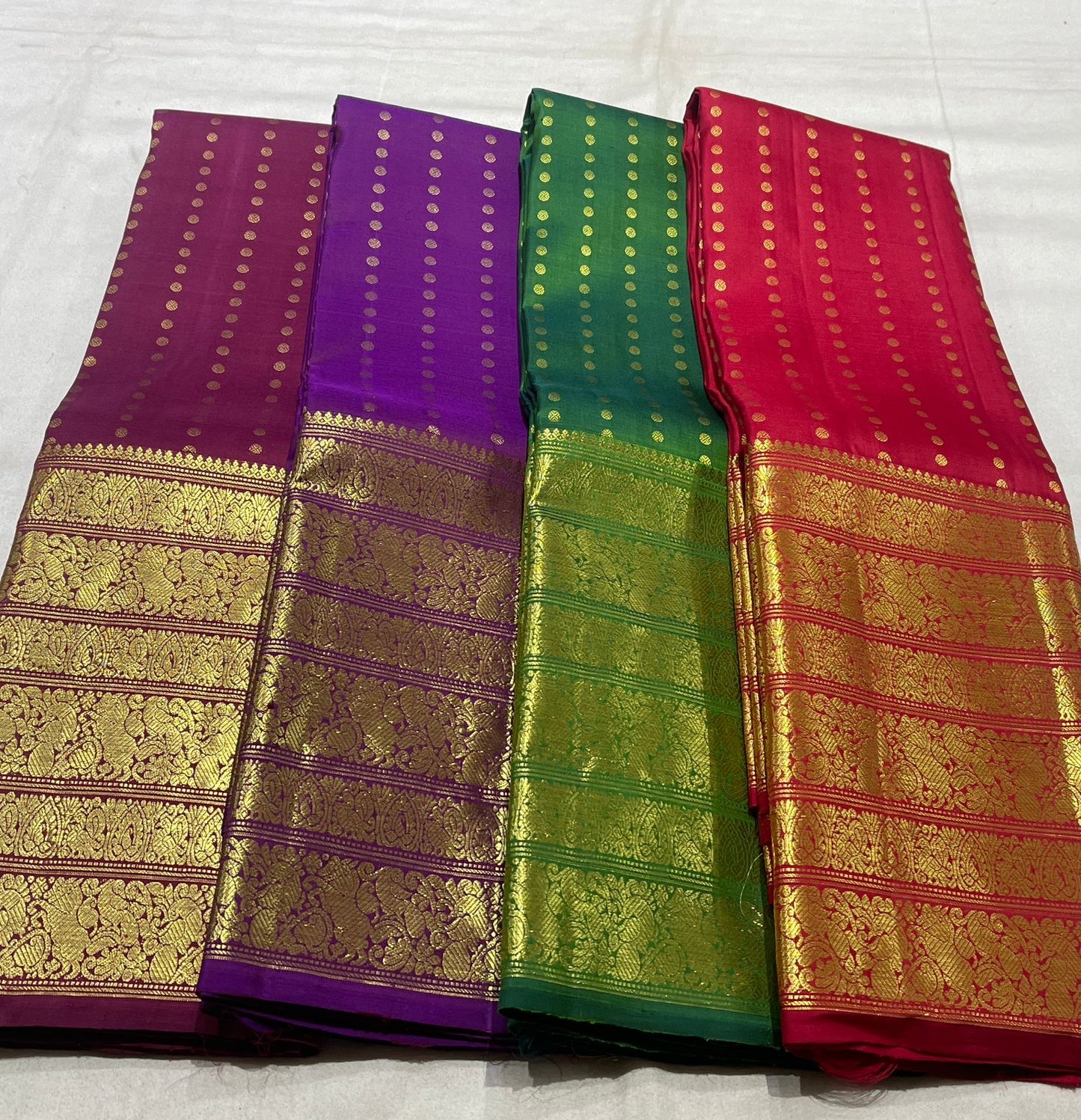 Kanchipuram silk saree pearl white folded drape showing gold zari craftsmanship