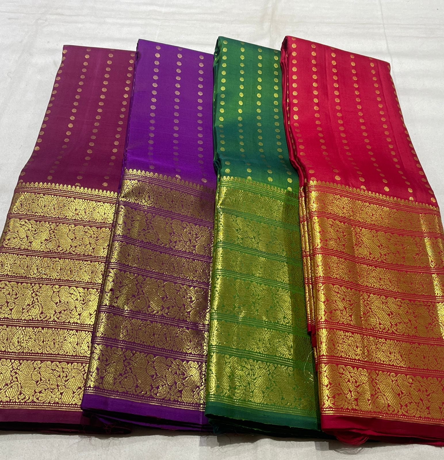 Kanchipuram silk saree pearl white folded drape showing gold zari craftsmanship