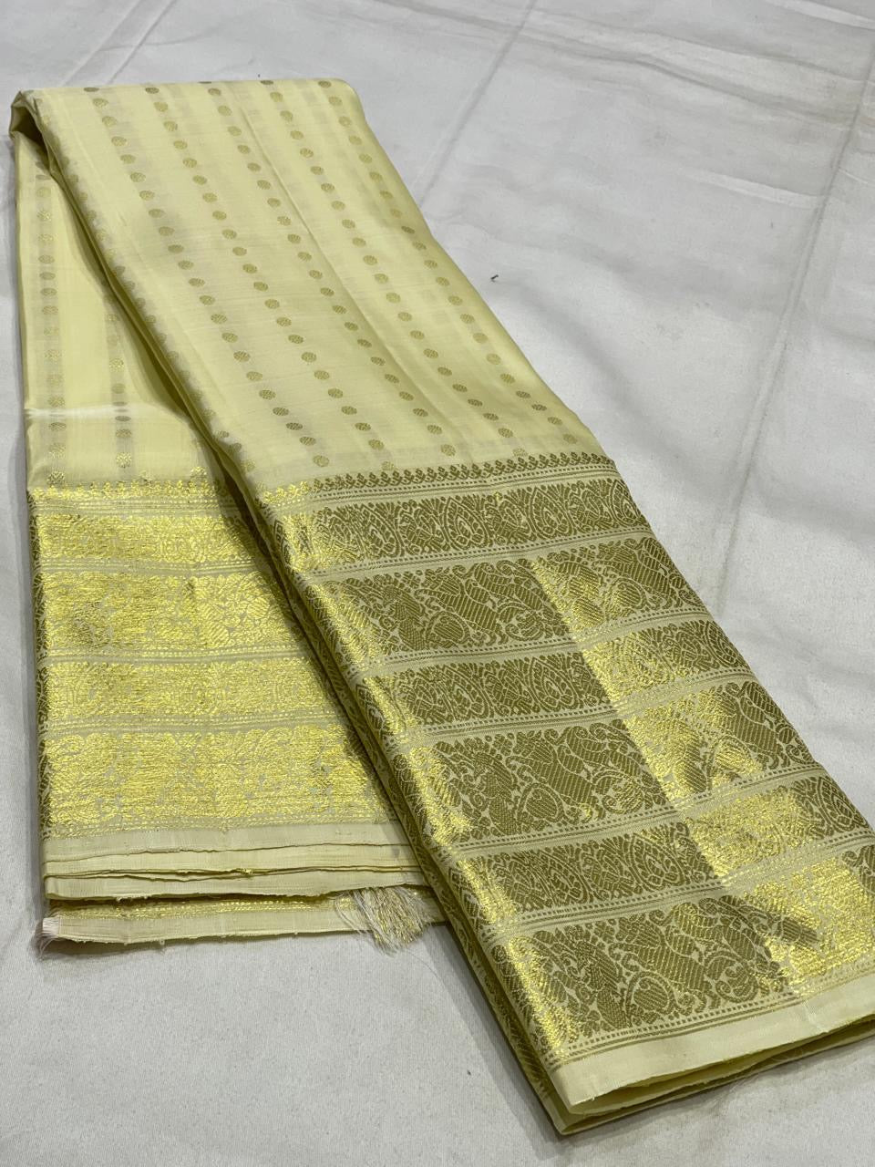 Pearl white Kanchipuram silk saree with pale gold zari varisaipet border folded view