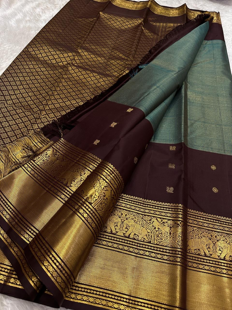 Kancheepuram silk saree brown panel with rich gold zari border close up