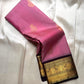 Pink Pure Kanchipuram Silk Saree with scattered gold buttas and black zari woven border shown on light fabric background