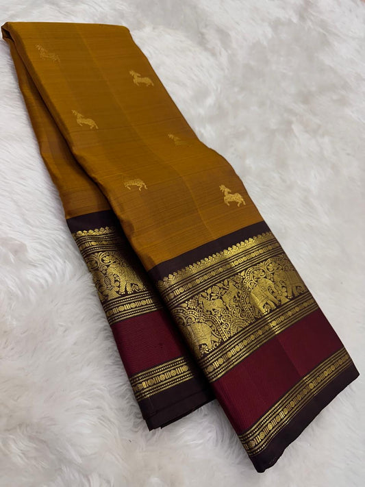 Ponvandu golden yellow Kanchipuram silk saree with crimson red border folded view