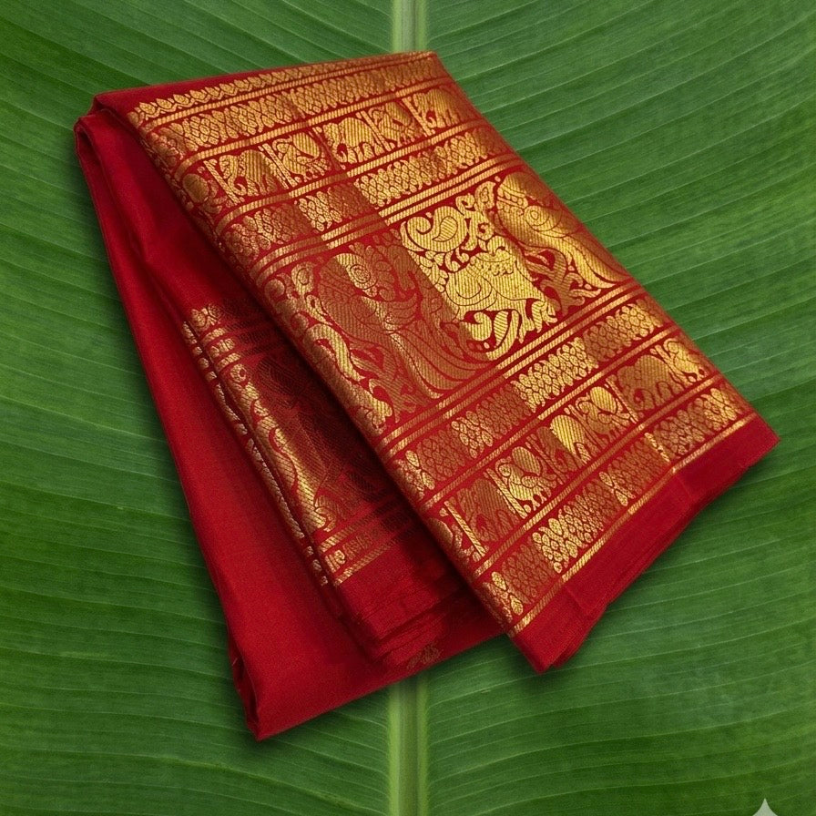 Kanchipuram silk saree in vibrant kumkum red with antique gold border Vanasringaram weave folded view