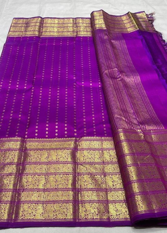 Purple Kanjivaram silk saree draped view showing structured gold border and dotted zari motifs
