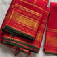 Red Kanjivaram silk saree with traditional mayil butta motifs and bottle green selvedge draped view