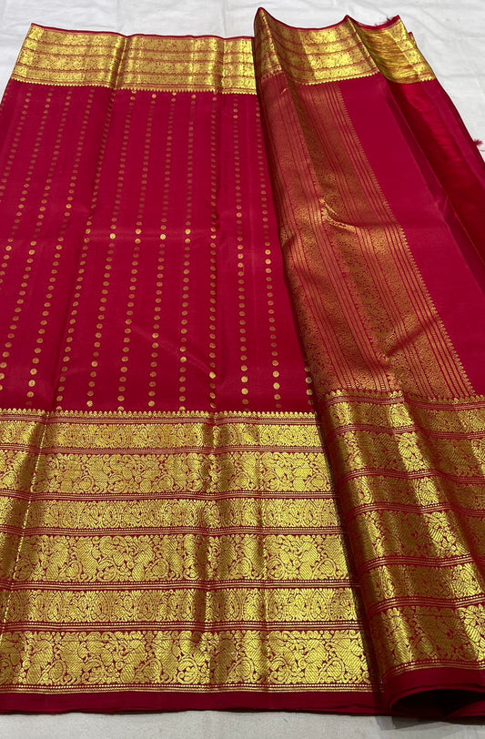 Poppy red Kanchipuram silk saree folded view with gold varisaipet border and zari butta