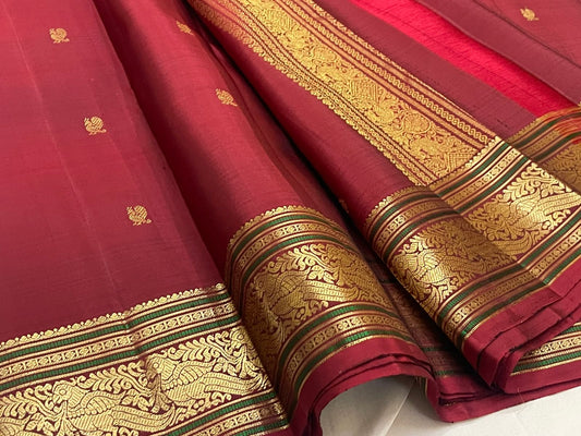 Pomegranate red Kanchipuram silk saree with gold mayil butta folded view