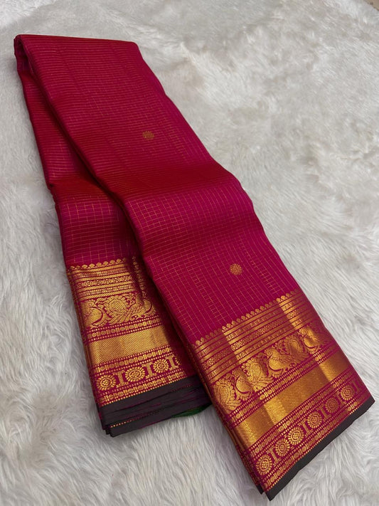 Crimson red Kanjivaram saree with gold zari grid pattern and green selvedge detail