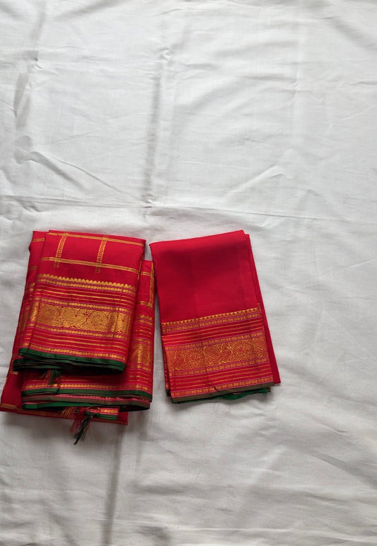 Red pure Kanchipuram silk saree with zari kattam mayil butta and bottle green selvedge folded view