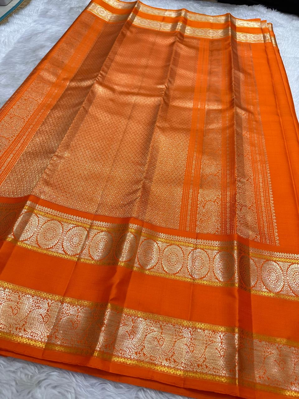 traditional tested zari detail on amber flame Kanchipuram silk saree