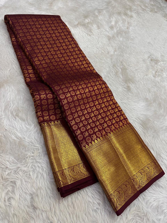 deep burgundy kanjivaram silk saree gold zari peacock motifs draped styling