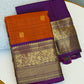 Folded view of rust orange purple Kanchipuram silk saree with intricate vanasringaram animal motifs