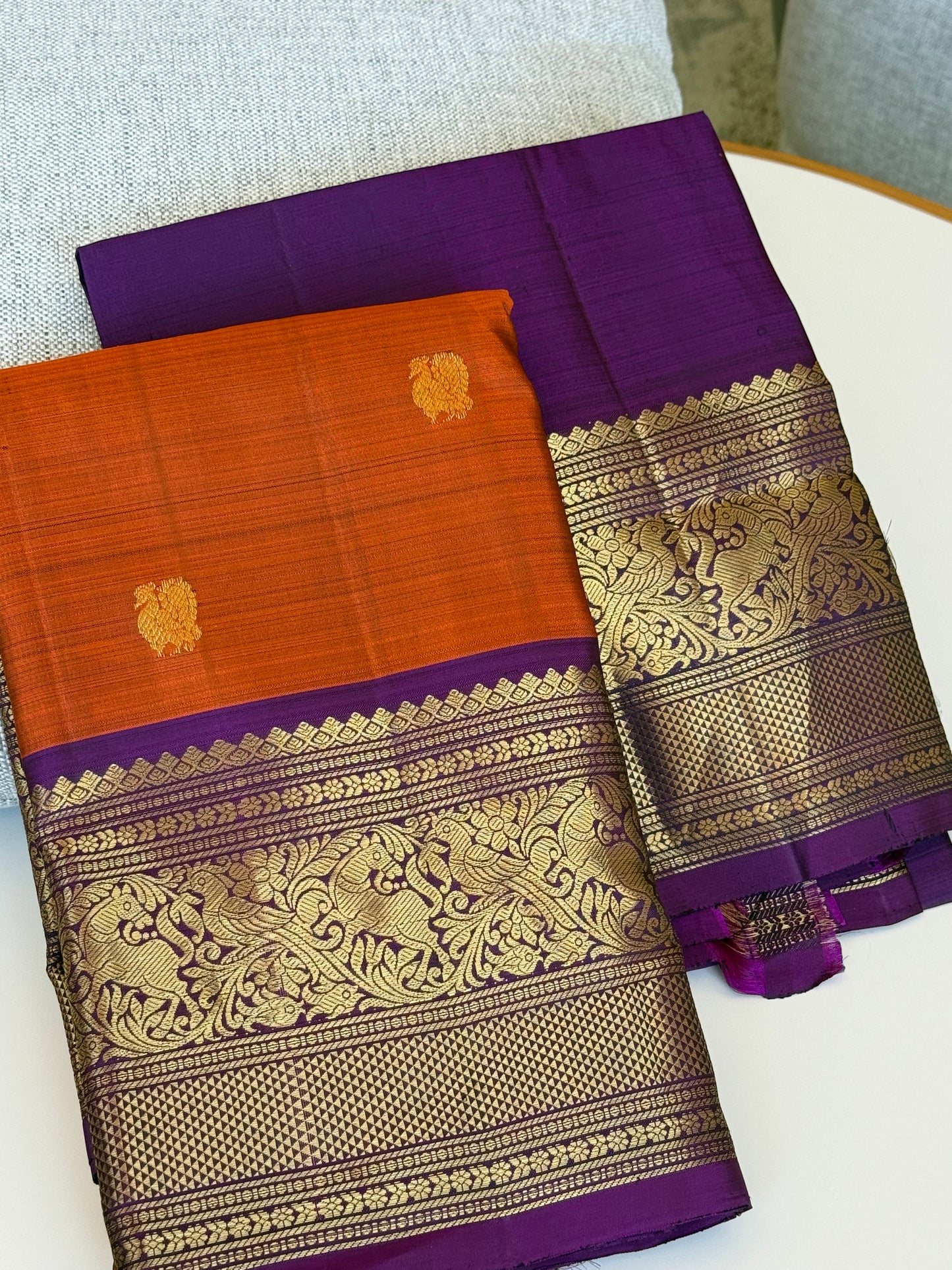Rust orange and purple pure Kanchipuram silk saree with vanasringaram motifs and 3g zari draped view