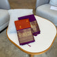 Radiant purple border with rust orange silk Kanjivaram saree featuring traditional fauna Kanchipuram motifs