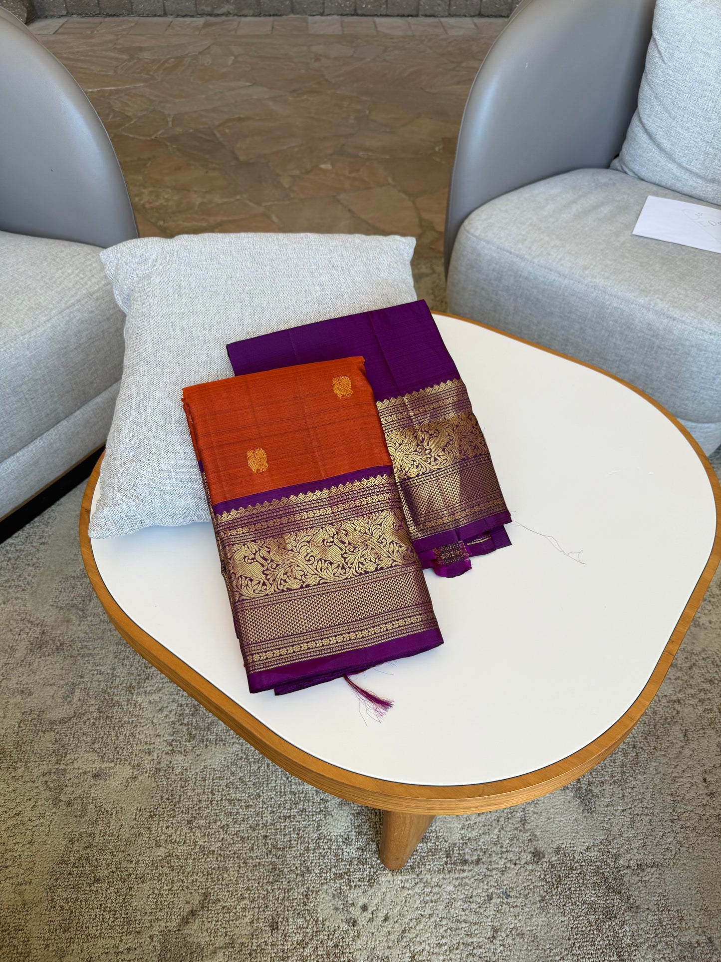 Radiant purple border with rust orange silk Kanjivaram saree featuring traditional fauna Kanchipuram motifs