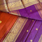 Closeup of 3g zari detailing on rust orange and purple Kanchipuram silk saree with vanasringaram design