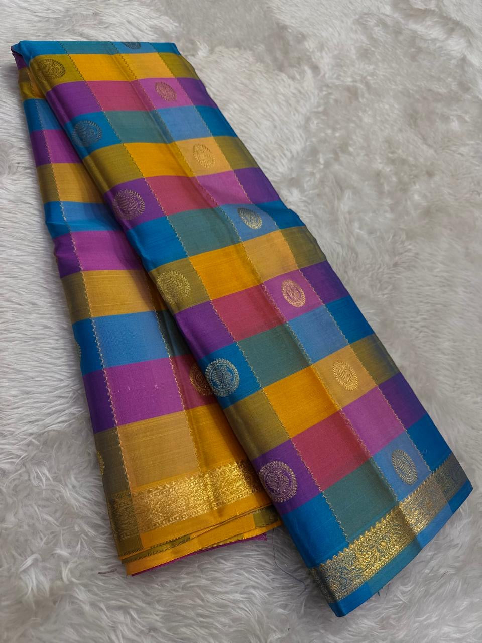 Kanjivaram silk saree yellow blue pink check pattern draped view