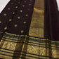 Coffee brown pure silk Kanchipuram saree with antique gold mayil chakram buttas, deep green accents, and a detailed peacock and arai maadam pallu.
