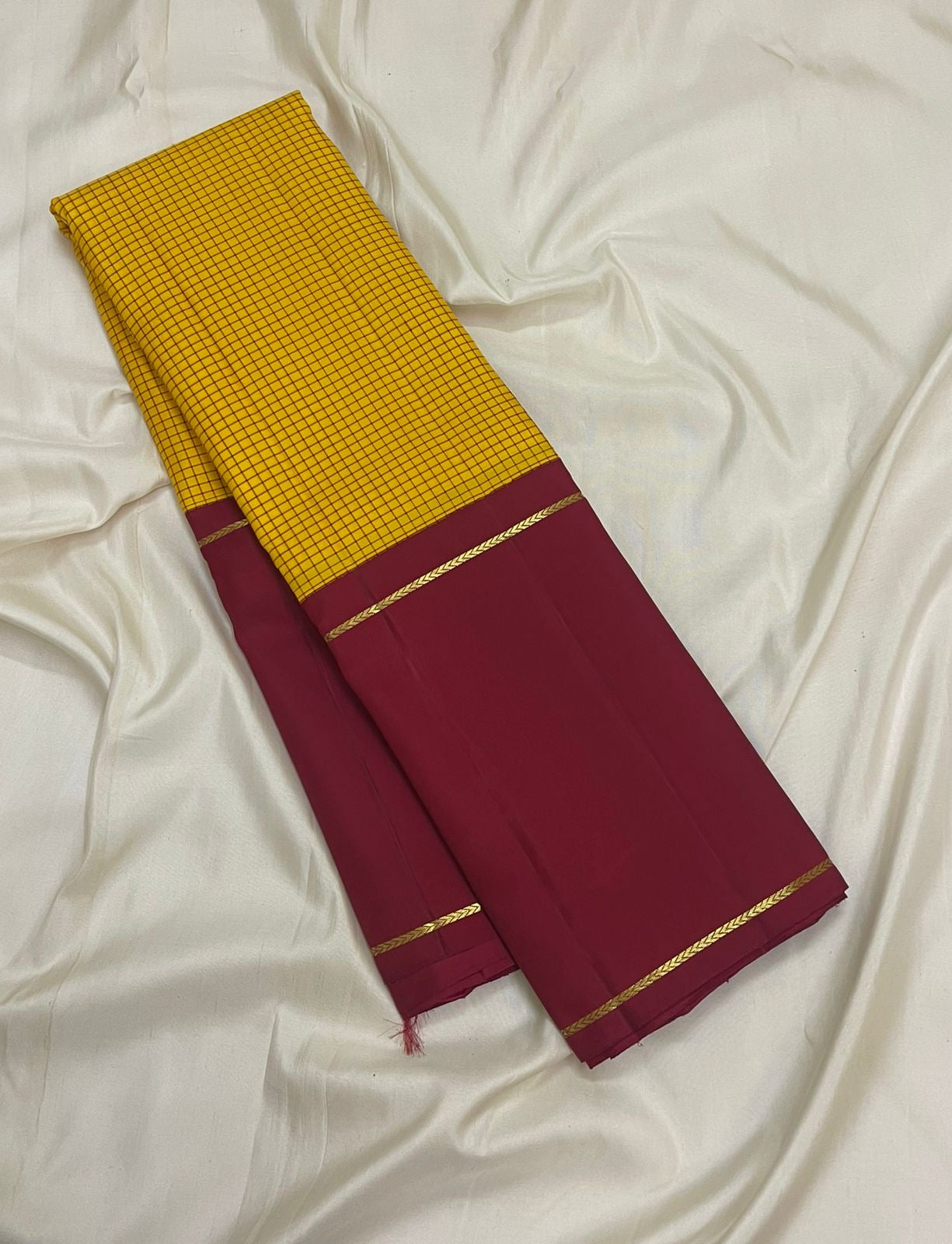Saffron yellow Kanchipuram silk saree with kanchi kattam checks folded view