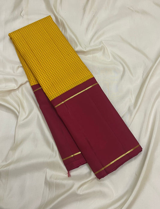 Saffron yellow Kanchipuram silk saree with kanchi kattam checks folded view