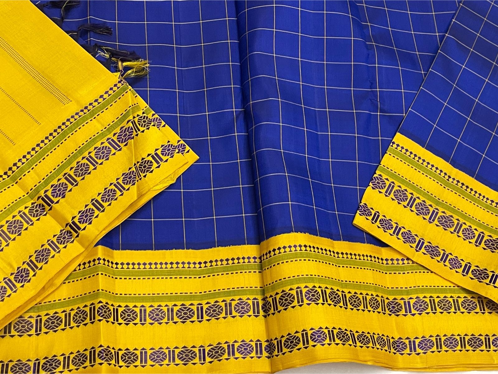 Full view of royal blue checked pure Kanchipuram silk saree with mustard yellow pallu section and contrast woven borders