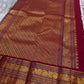 Full view of maroon zari woven pallu with dense patterning and wide border, available in the USA