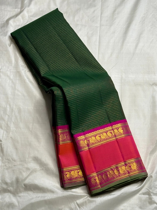 Radiant green Kanchipuram silk saree with raspberry pink border traditional gold zari kattam detail