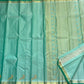 Needle fine Vairaoosi lines across a mint aqua Kanchipuram pure silk saree with a soft natural sheen