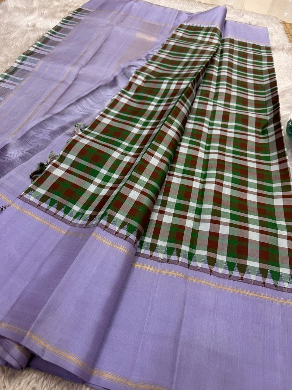 Mullai Lavender Kanchi Kattam Kanchipuram silk saree with gold zari bands, styled for a wedding rehearsal celebration.