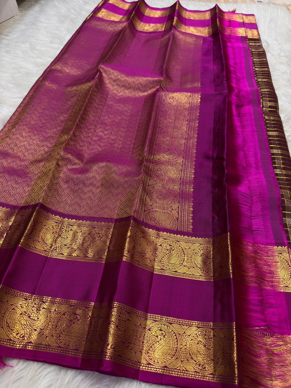 Oodha magenta Pure Kanchipuram Silk saree with Rettapet twin-band border worn at a wedding rehearsal celebration