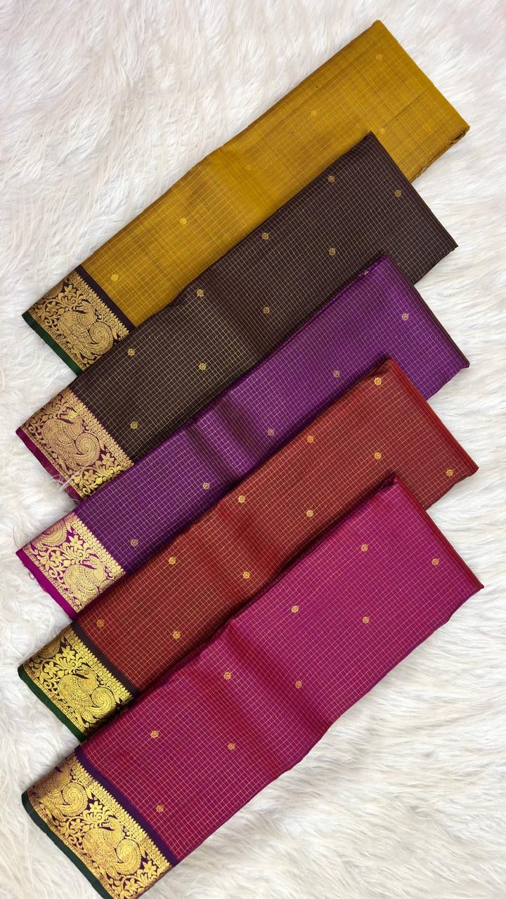 Vadamalli purple Kanchipuram silk saree folded, showing checked body, peacock border and pallu