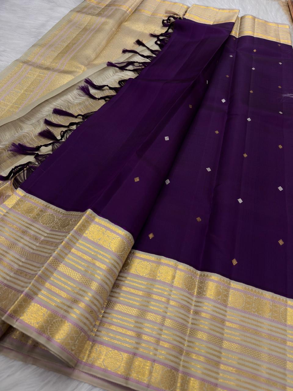 Deep purple Kanchipuram silk saree with scattered zari buttas and wide sandalwood gold Varisaipet border.