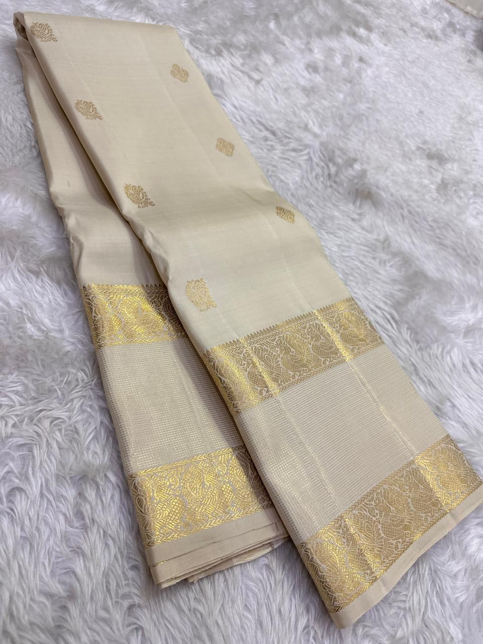 Stylized bird motifs in gold zari border on Warm Ivory Kanchipuram silk
