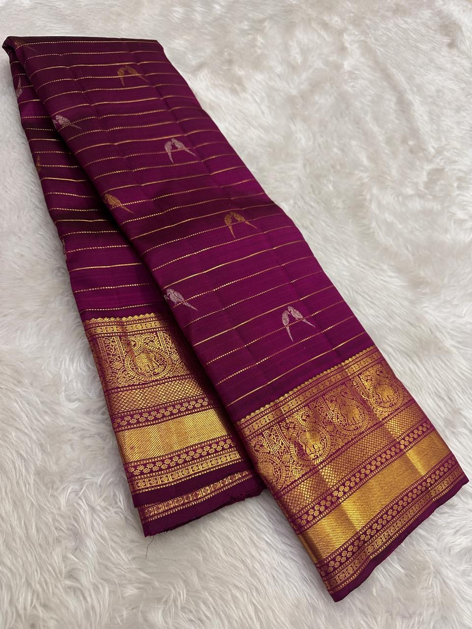 Naval Pazham purple Kanchipuram silk saree with fine gold zari lines in the Vairaoosi weave