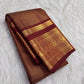 Warm arakku red Kanchipuram zari kattam saree, showing body, border and detailed gold zari pallu