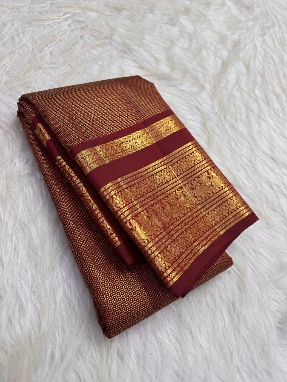 Warm arakku red Kanchipuram zari kattam saree, showing body, border and detailed gold zari pallu