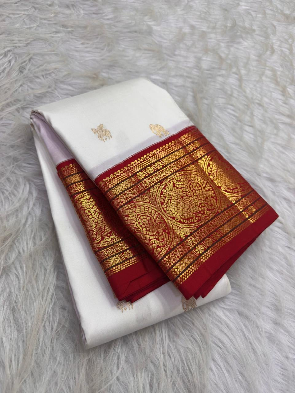 Warm ivory handwoven pure silk Kanchipuram Kai Korvai saree with gold zari flying horse buttas and temple-red border