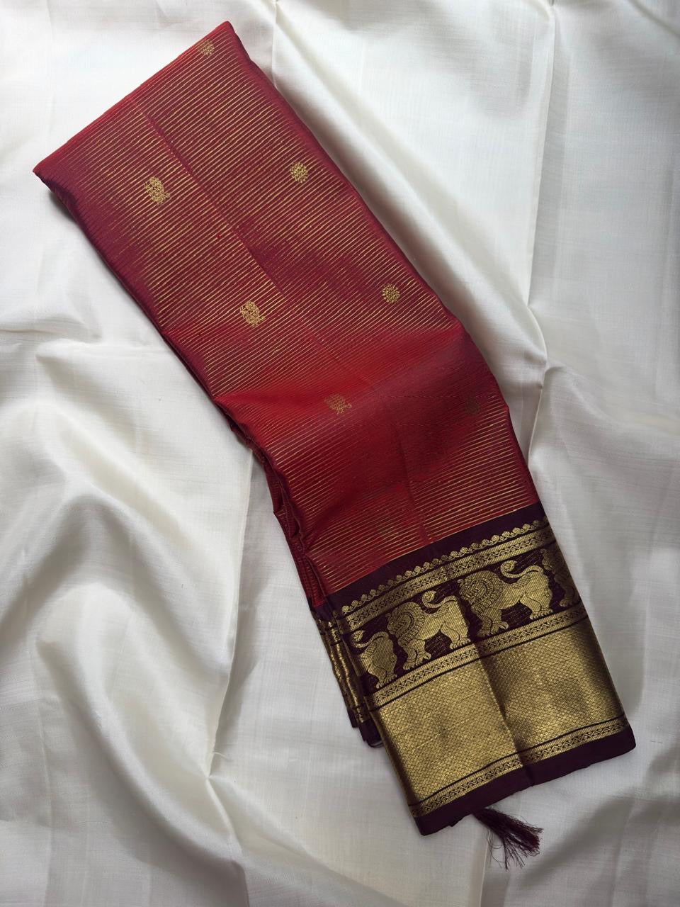Kanchipuram Vairaoosi silk saree in rust red — zari butta motif close-up