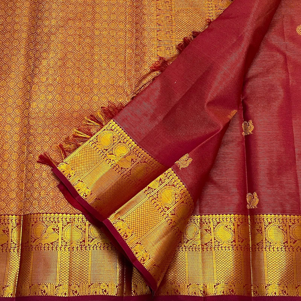 Close-up of the fine Vairaoosi weave texture on the Arakku maroon Kanchipuram silk saree